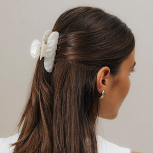 Unsere Haarklammer in Shell (8,5 cm) aus Bio-Acetat im eleganten Half-Bun – getragen von einer Frau mit dunkelbraunem Haar.